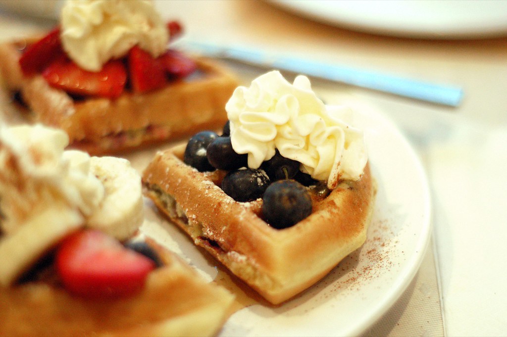 A waffle with blueberries and lemon