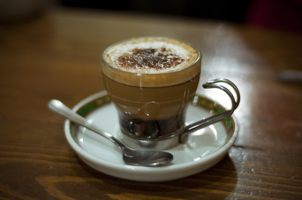 A honey-cinnamon latte in a glass cup