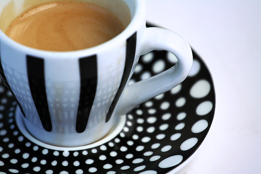 A double espresso with thick crema in a striped cup