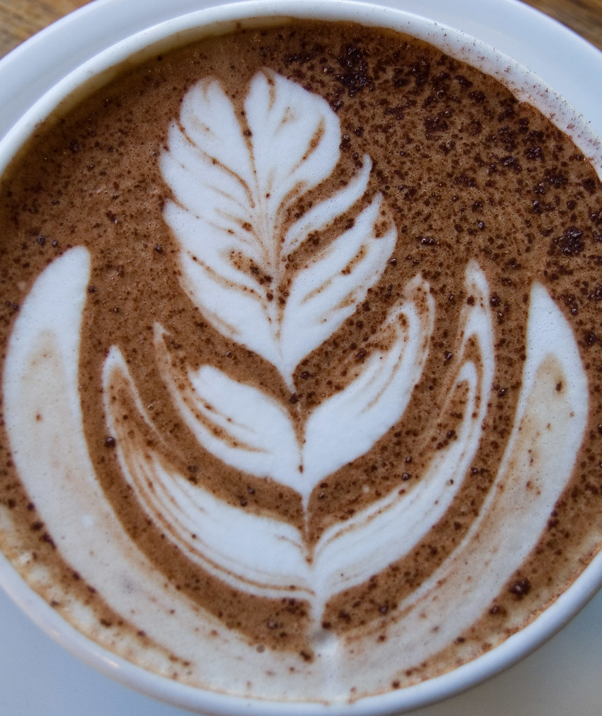 A nutty latte with rosetta art and cocoa