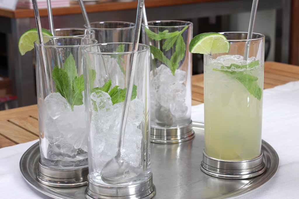 Tall mint drinks over crushed ice on a tray