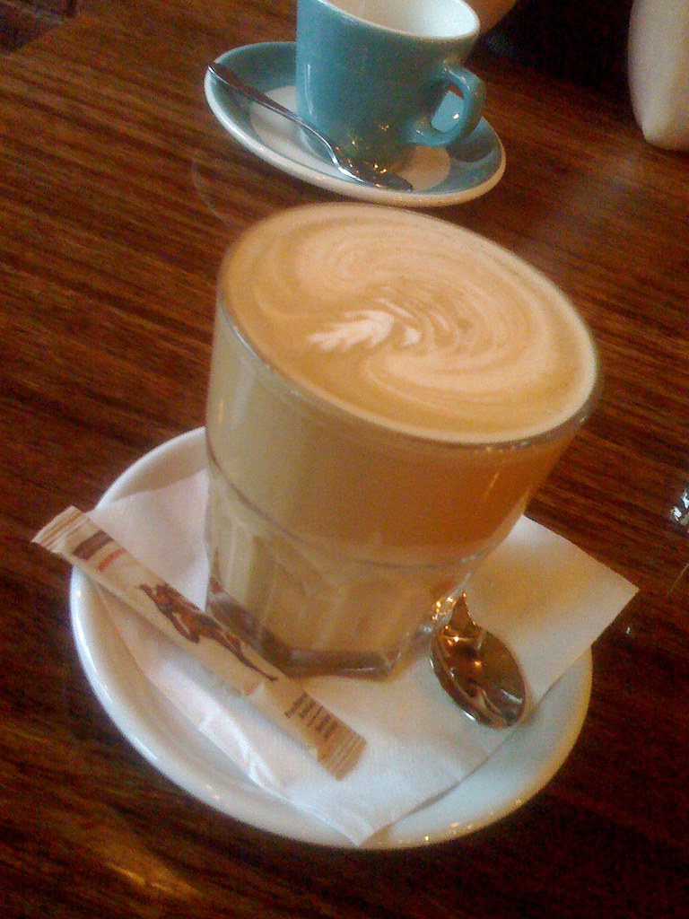A lavender latte in a glass